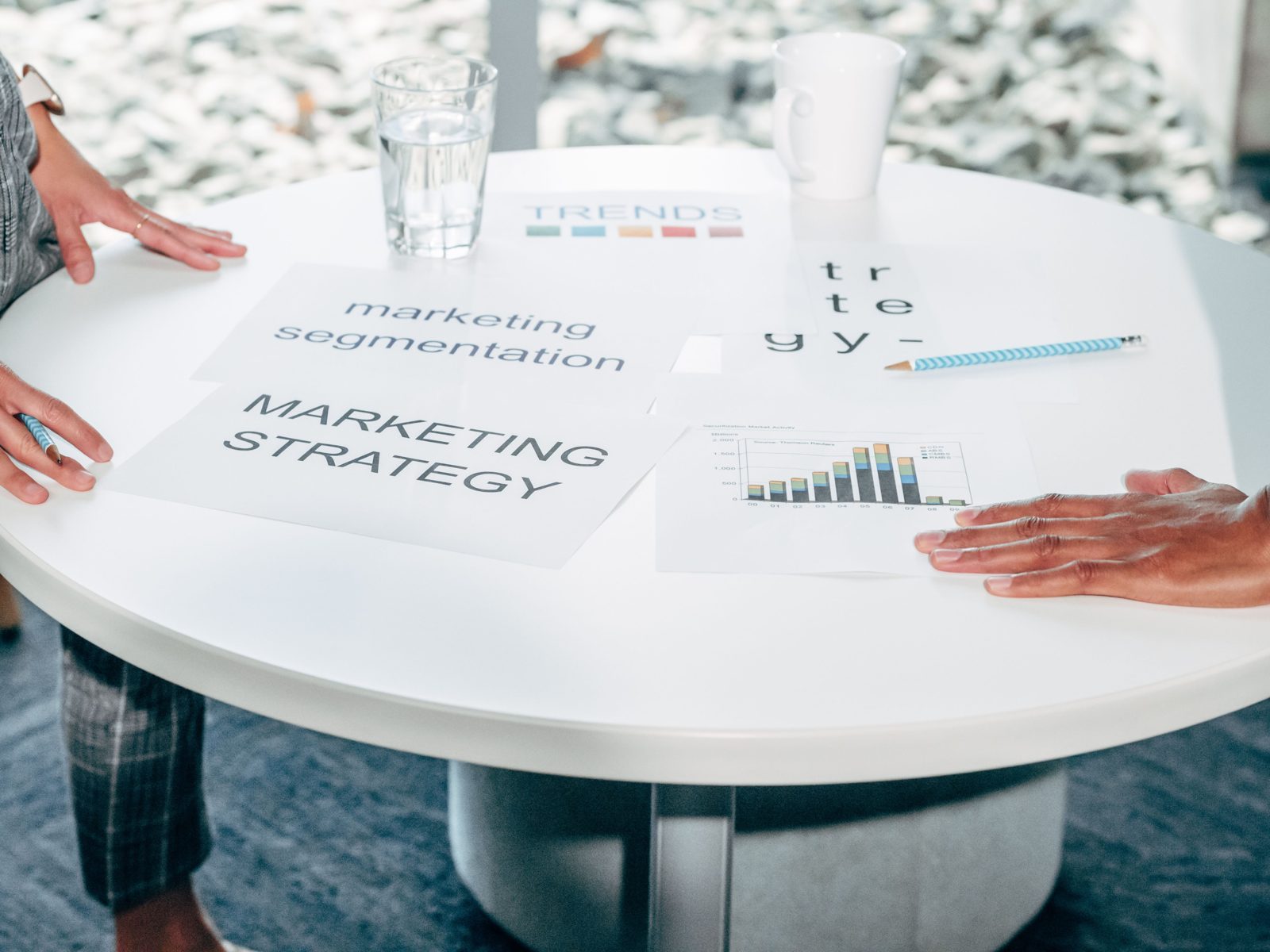 A marketing strategy planning session with charts on a table